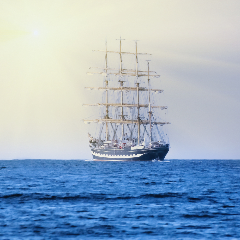 a tall ship is sailing in open waters